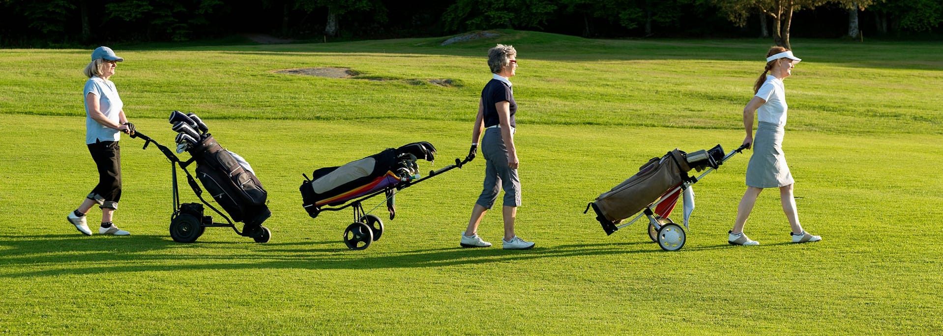 three women on a golf fairway