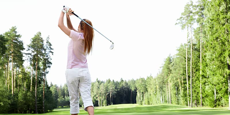young woman playing golf